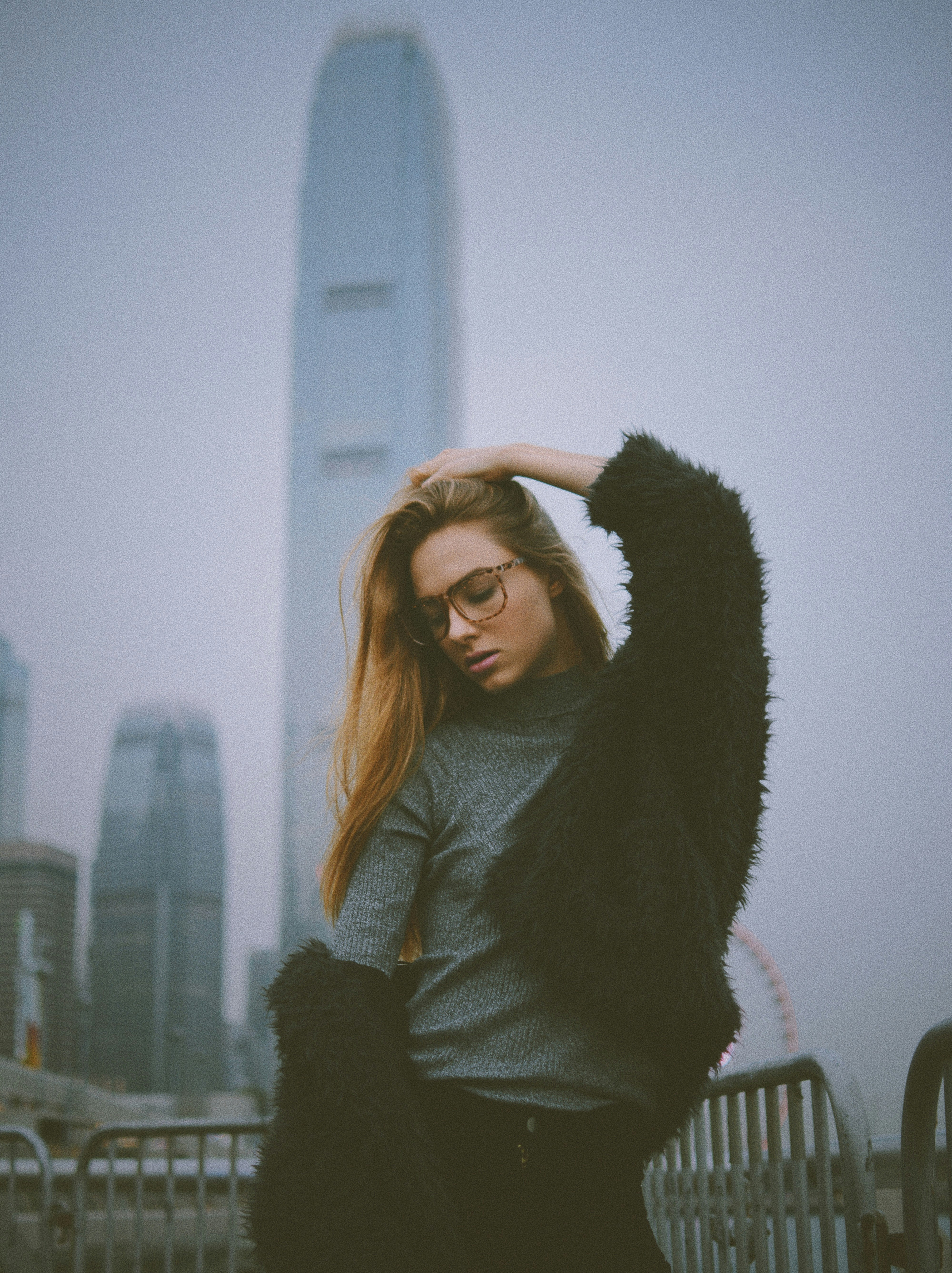 selective focus of woman posing with building background